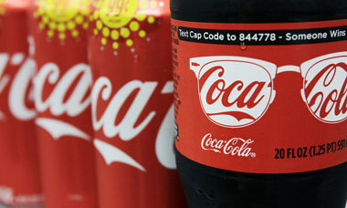 A variety of Coca-Cola cans and bottles are displayed on a counter at a local store in West Bath, Maine, Monday, Aug. 8, 2011, in this photo illustration. Coca-Cola Bottling Co. reports quarterly financial results Tuesday, Aug. 9, after the market close.