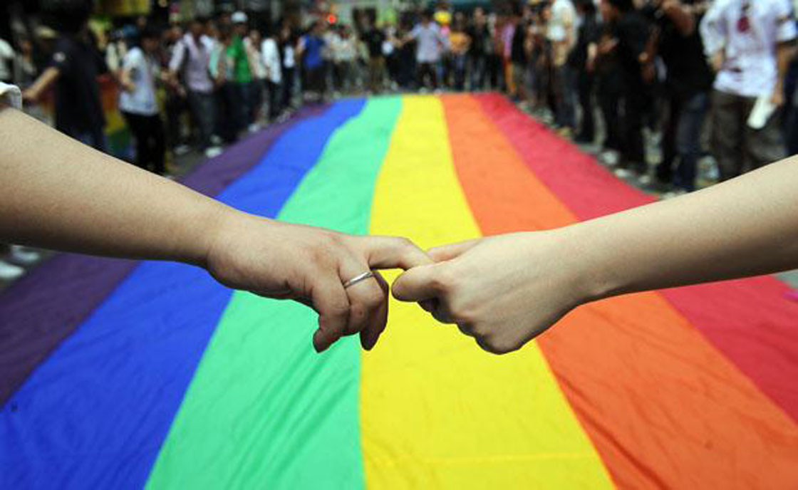 Gay and lesbian activists form a human chain around a rainbow flag during celebrations marking the fourth annual International Day Against Homophobia (IDAHO) in Hong Kong on May 18;2008.