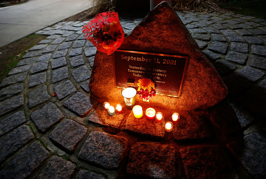 Candles are lit and flowers are left outside of Stratford High School during a candlelight vigil in honor of Victoria Soto, the first-grade teacher at Sandy Hook Elementary School who was shot and killed while protecting her students, on December 15, 2012 in Stratford, Connecticut. Twenty-six people were shot dead, including twenty children, after a gunman identified as Adam Lanza opened fire in the school. Lanza also reportedly had committed suicide at the scene. A 28th person, believed to be Nancy Lanza was found dead in a house in town, was also believed to have been shot by Adam Lanza.  