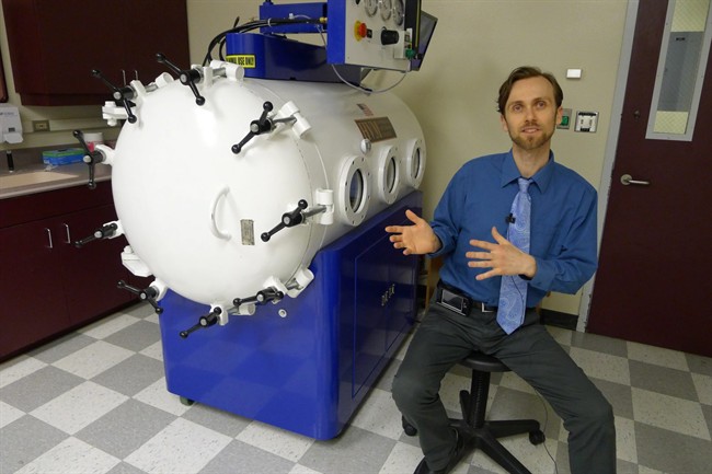 In this photo taken Jan. 25, 2013, Dr. Justin Shmalberg, a veterinarian and professor at the University's of Florida's College of Veterinary Medicine, said that hyperbaric oxygen chambers are being used to treat inflammation, wounds and other conditions in pets, in Gainesville, Fla. Shmalberg treated a small dog in this chamber. (AP Photo/Tamara Lush).