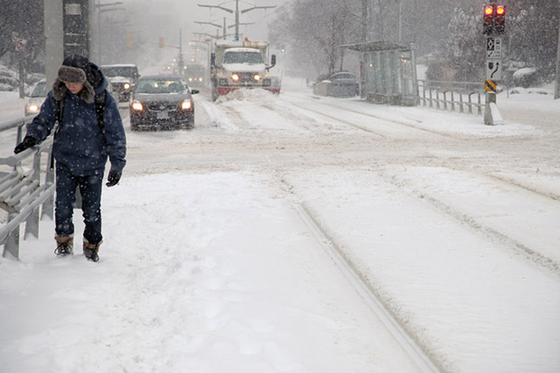 Commuters trek in snow following a storm in Toronto on Feb. 8, 2013.