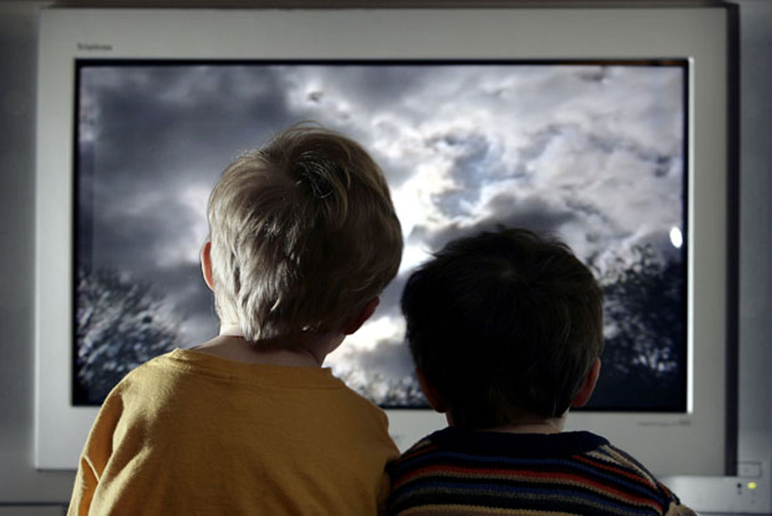 In this photo illustration two young child watch television at home;January 27, 2005 in London;England.