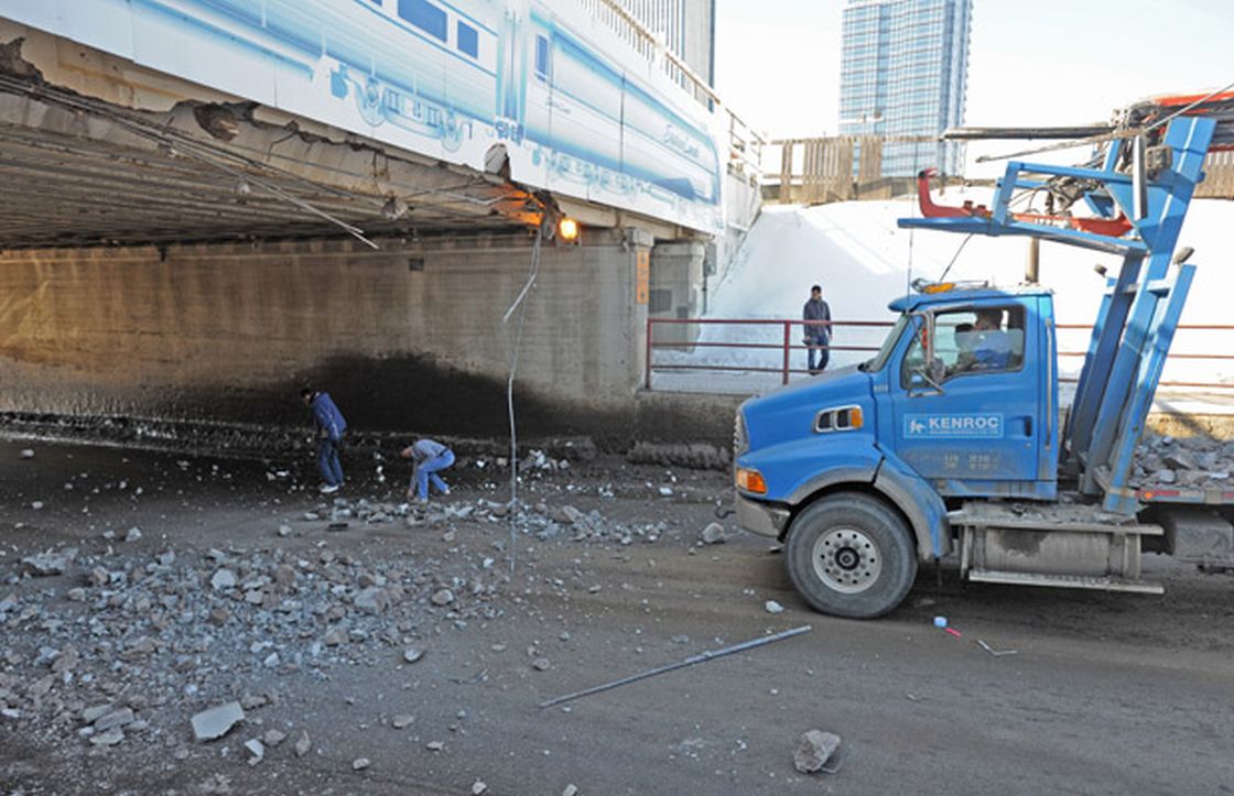 A truck heading south on 97th Street struck the bridge at 105th Avenue. A concrete girder broke apart into pieces and fell onto the road. 97th Street was later closed to all traffic.