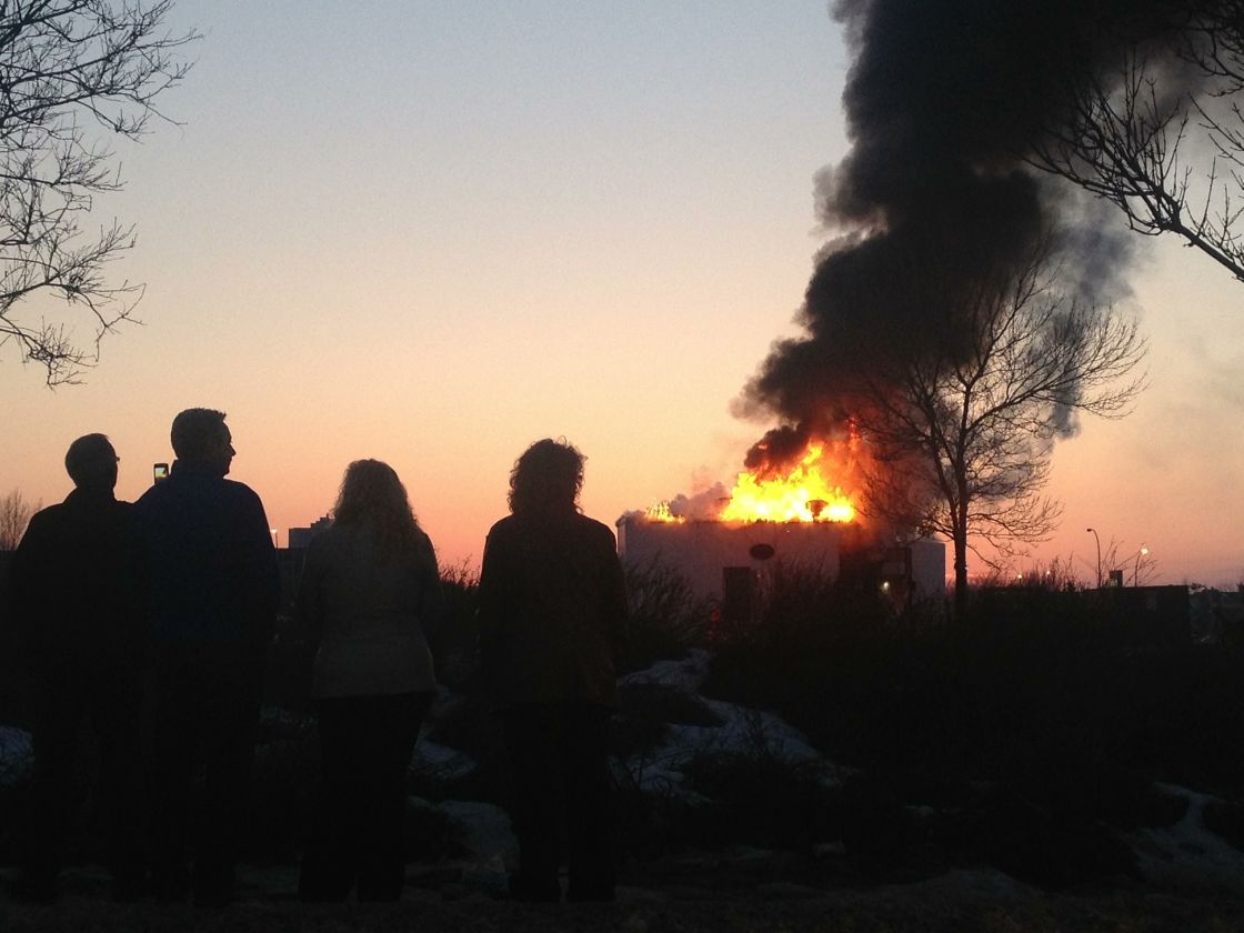 Edmontonians look on as Bubba's BBQ & Smoke House goes up in flames Thursday, March 28.