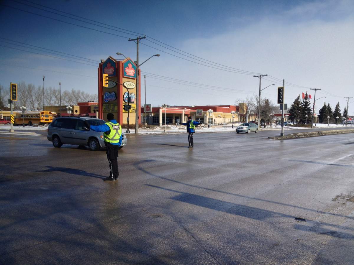 Cadets direct traffic at McPhillips Street and Jefferson Avenue after a power outage on Sunday.