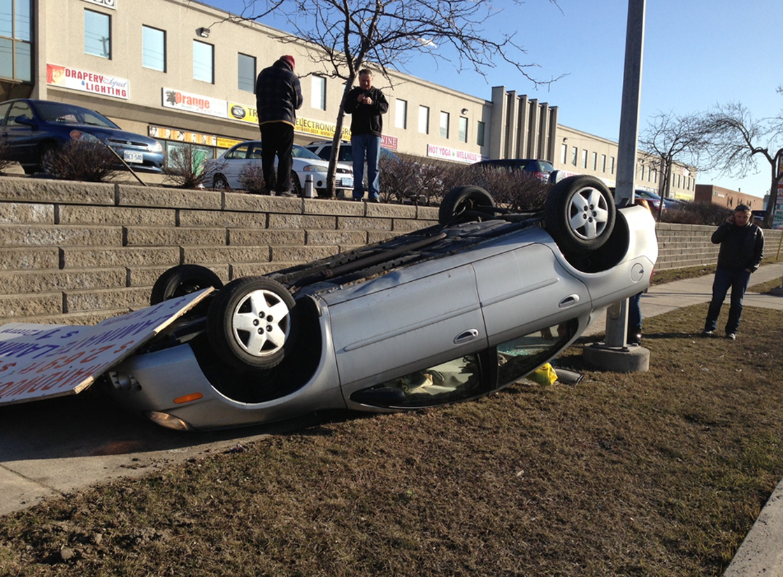 Car drives off parking lot (Toronto, Mar. 30, 2013)
