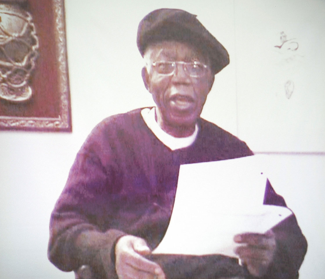 Nigerian novelist Chinua Achebe is seen on a video as he reads his keynote speech during the 25th Silver Jubilee lecture of the Guardian newspaper in Lagos on October 9, 2008. Kenyan Prime Minister Raila Odinga spoke on 'Democracy and the Challenge of Good Governance in Africa' at the lecture.