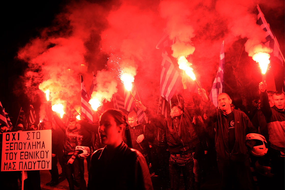 Members of the ultra nationalist party Golden Dawn chant the Greek national anthem outside the German embassy in Athens on March 22, 2013. Some 1,000 nationalists protest against the EU austerity plans for Cyprus.