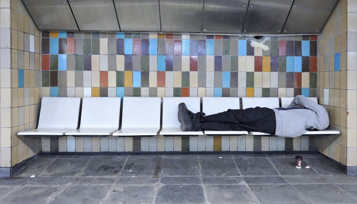 A homeless man sleeps on a bench in Montreal's Metro.