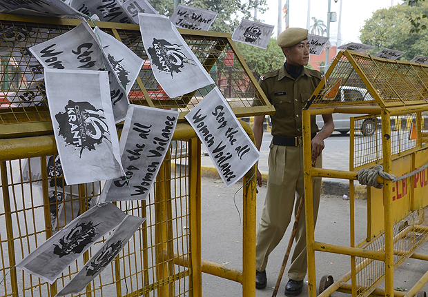 An Indian police officer looks on near a string of anti-rape posters hung over a police barricade at Janatar Mantar in New Delhi on January 28,2013. A court said the sixth suspect in last month's grisly gang-rape of a Delhi student was a minor and would be tried under India's relatively-lenient laws meant for juveniles.