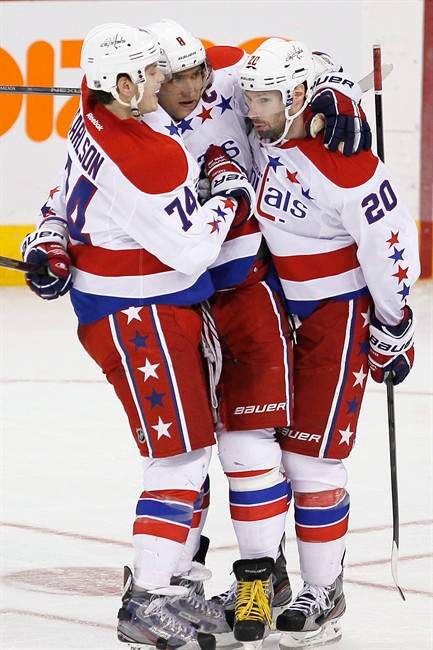 Washington Capitals' Alex Ovechkin (8), John Carlson (74) and Troy Brouwer (20) celebrate Ovechkin's goal against the Winnipeg Jets during the third period on Thursday.