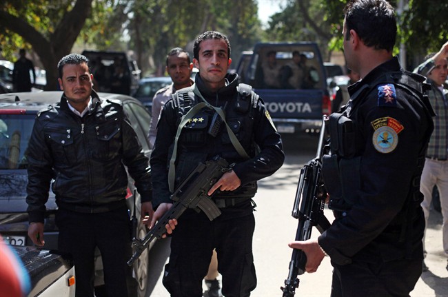 Egyptian police officers take positions during the arrest of Ahmed Qaddaf al-Dam, cousin of Libya’s former dictator Moammar Gadhafi, not pictured, in Cairo, Egypt, Tuesday, March 19. 2013. Egyptian security forces arrested a cousin of Libya’s former dictator Moammar Gadhafi on Tuesday following an hours-long siege of his home in central Cairo, a security official and witnesses said. 