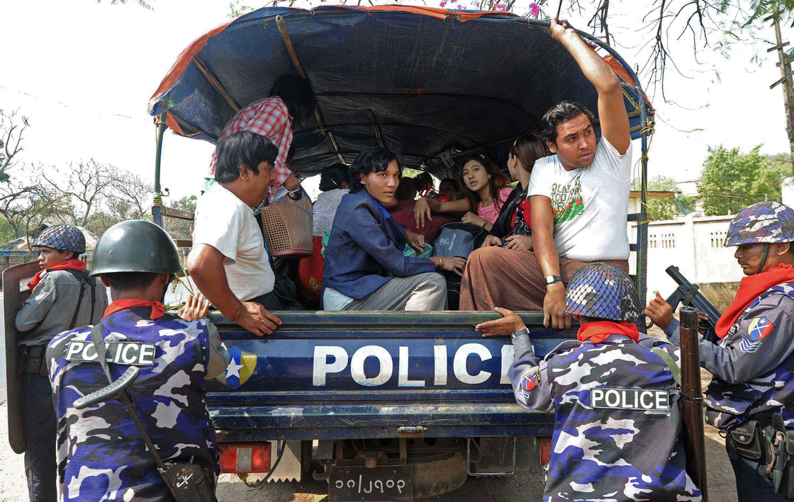 Muslim residents evacuate their houses to a temporary relief camp under police escort in riot-hit Meiktila, central Myanmar on March 22, 2013. Charred bodies lay unclaimed on the streets of a riot-hit town in central Myanmar, witnesses said, as global pressure mounted for an end to the Buddhist-Muslim unrest. Parts of Meiktila have been reduced to ashes in the most serious communal violence to hit the former junta-ruled nation since last year, leaving the authorities struggling to bring the situation under control. 