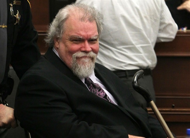 In thisfile photo, Richard Beasley smiles at his sister Sherri Beasley as he is wheeled into Summit County Common Pleas Judge Lynne S. Callahan's courtroom in Akron, Ohio.