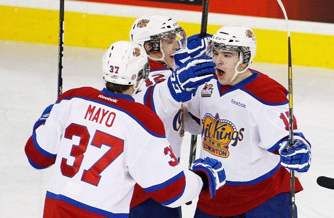 Edmonton Oil Kings Luke Bertolucci, right, celebrates his goal with teammates Cole Benson and Dysin Mayo, left, against the Kootenay Ice at Rexall Place on March 29, 2013.