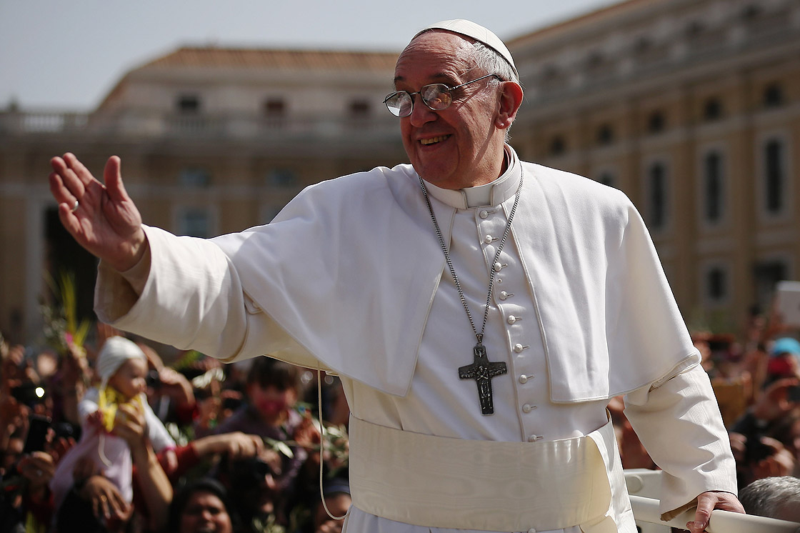 Pope Francis waves to the crowds during a drive around St. Peter's Square after delivering his blessing to the palms and to the faithful gathered in St. Peter's Square during Palm Sunday Mass on March 24, 2013 in Vatican City, Vatican.