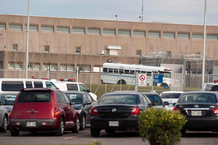 A Public Security bus sits behind barbed wire at the Orsainville detention centre in Quebec City Thursday, July 22, 2010. Quebec Provincial Police say three inmates have escaped from the Orsainville Detention Centre in Quebec City with the help of a green coloured helicopter.