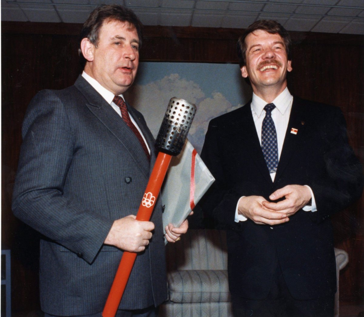 Montreal Mayor Jean Dore (right) hands over the Montreal Olympic torch to the Calgary Mayor Ralph Klein at Calgary City Hallo n Feb. 12, 1988. 
