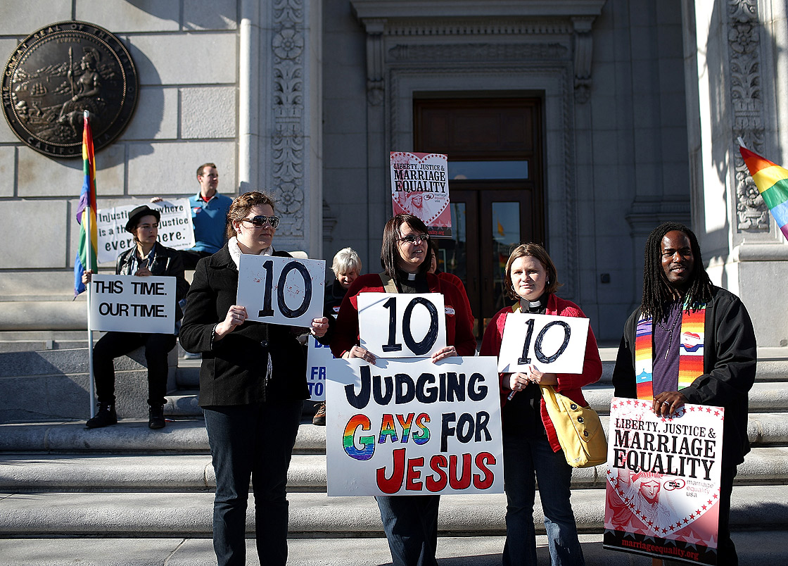 Supporters of same-sex marriage supporter Little Luciani hold signs during a rally in support of marriage equality on March 26, 2013 in San Francisco, California.