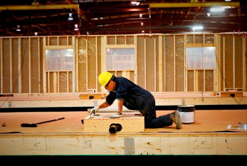 Construction tradesmen build portable housing for oil sands workers at the ATCO Structures facility in Calgary, Alta.