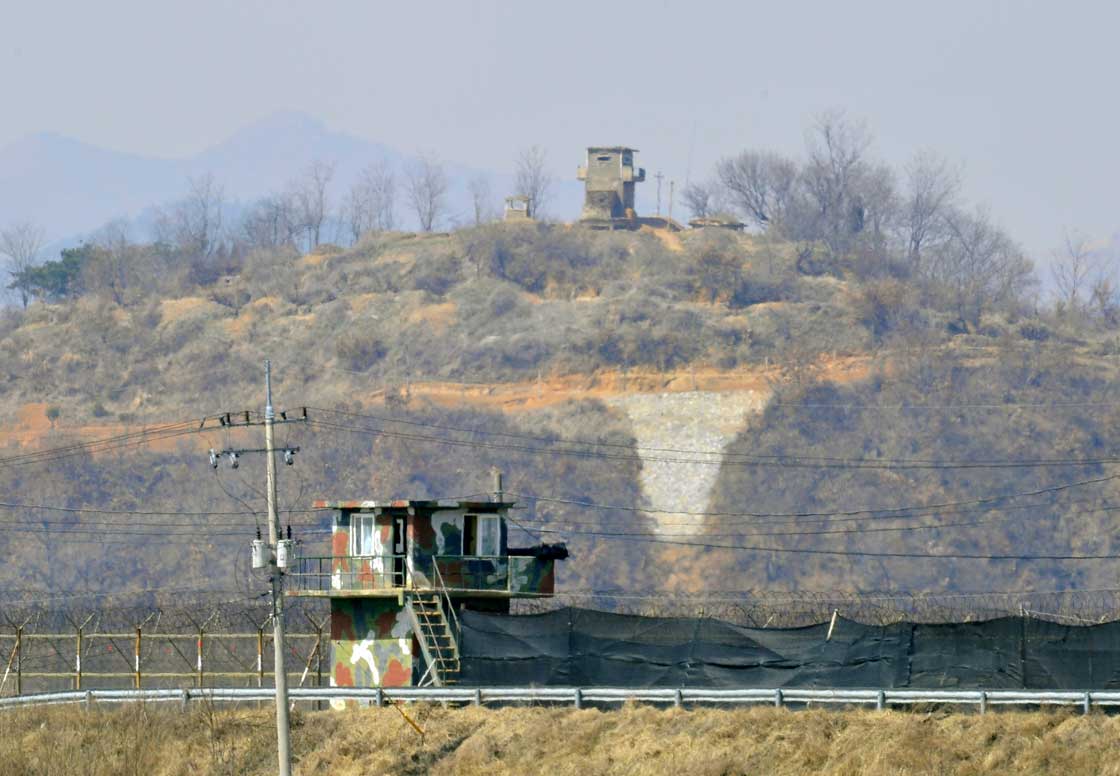 Military guard posts of South Korea (bottom) and North Korea (top) stand opposite each other as seen from in the border city of Paju on March 27, 2013.  