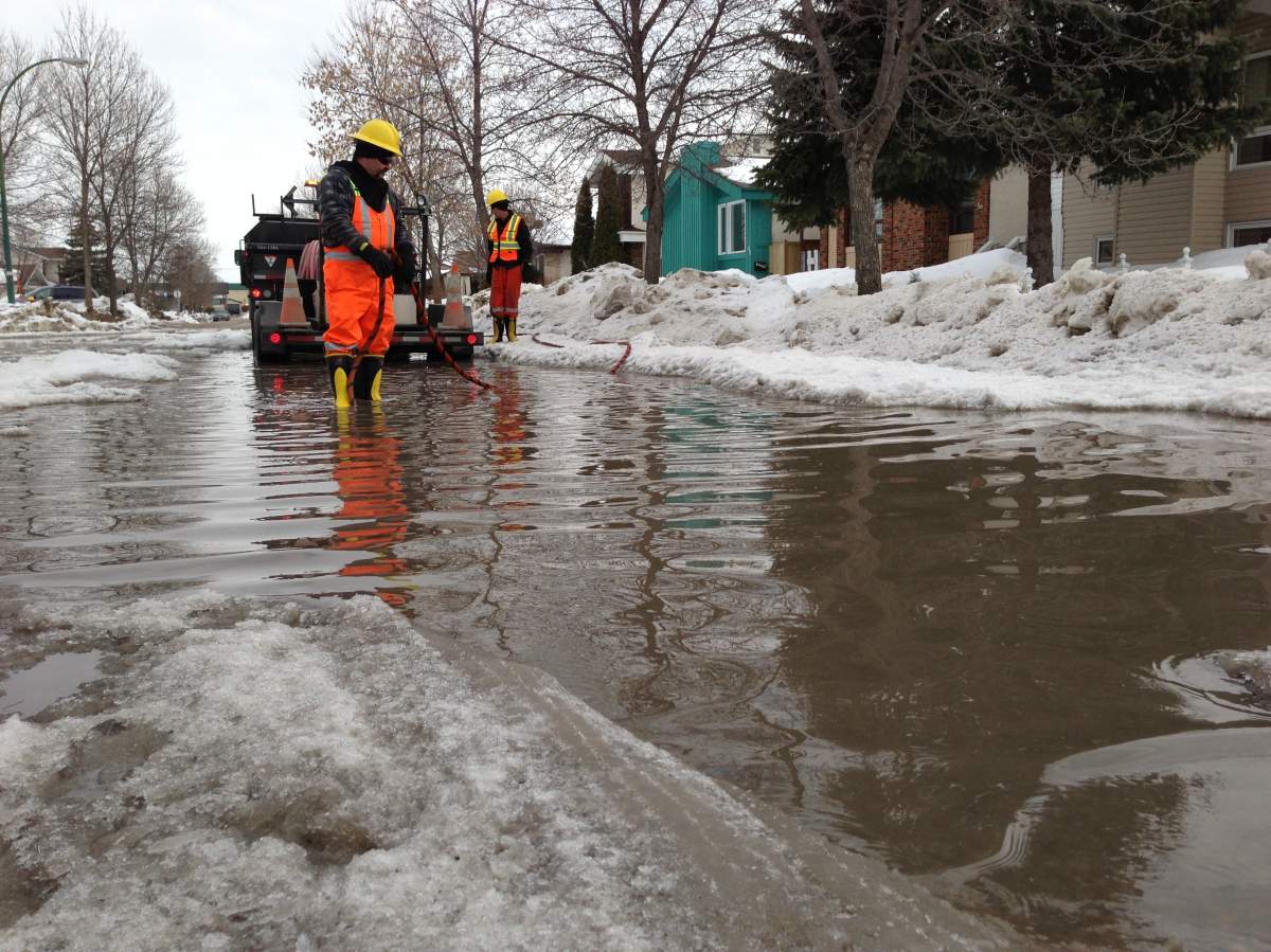 A city worker uses a steamer to clear a drain in Tyndall Park, Thursday.