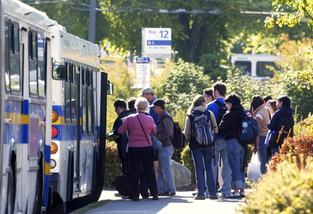 Students line up to board bus at University of B.C. in 2003 file photo. Provincial government has committed $34.5 million over next three years to extend U-Pass B.C. program that gives Metro Vancouver post-secondary students discounted transit passes.


