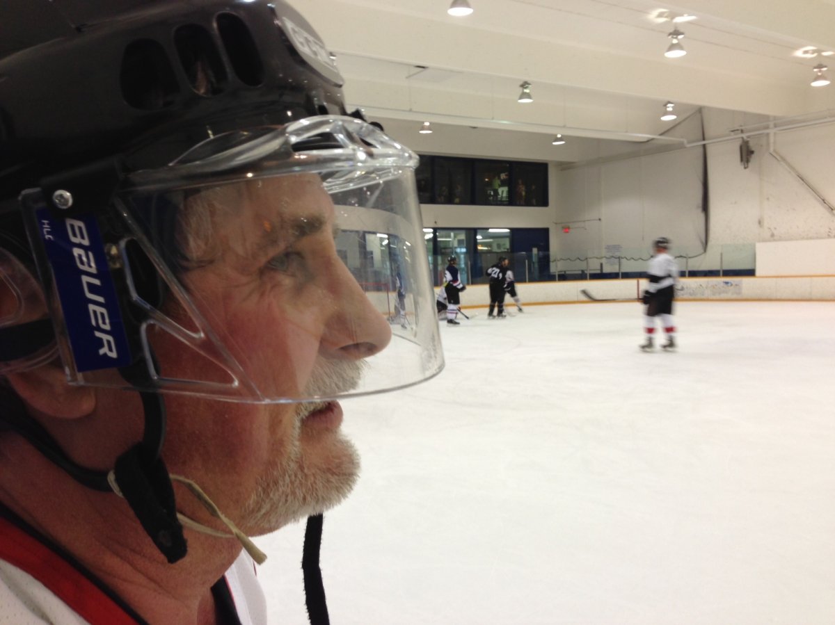 A recreational hockey player watches and plays the game through a visor at Canlan Ice Sports.
