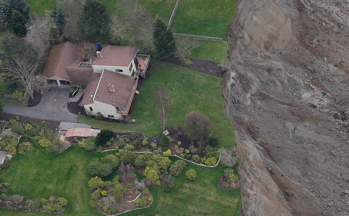 A house sits near the edge of a landslide, near Coupeville, Wash. on Whidbey Island, Wednesday, March 27, 2013.