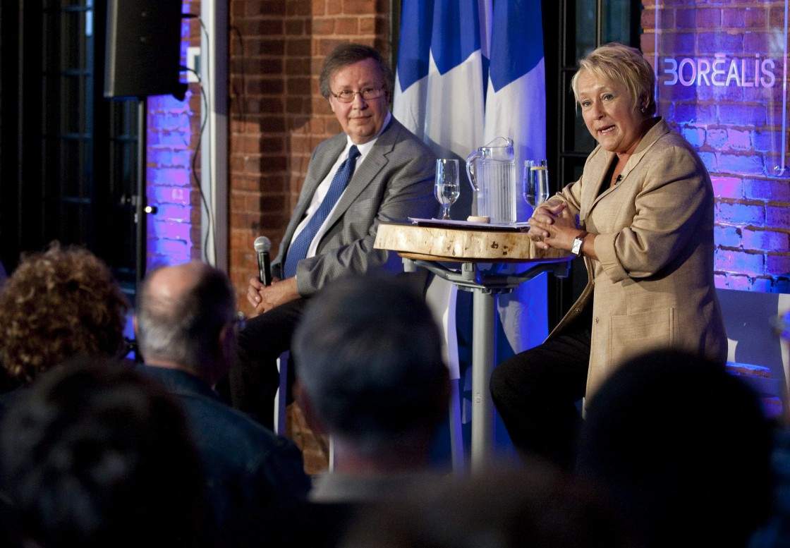 Parti Quebecois Leader Pauline Marois, right, speaks at a town hall meeting as party president Raymond Archambault, left, looks on, Tuesday, August 23, 2011 in Trois-Rivieres Que. Marois begins a province-wide serie of meetings to discuss her party's projects with the population.