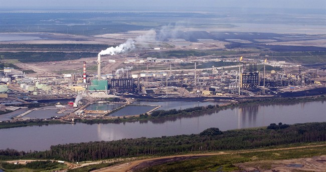 A Suncor mine facility along the Athabasca river as seen from a helicopter tour of the oil sands near Fort McMurray, Alta., Tuesday, July 10, 2012.