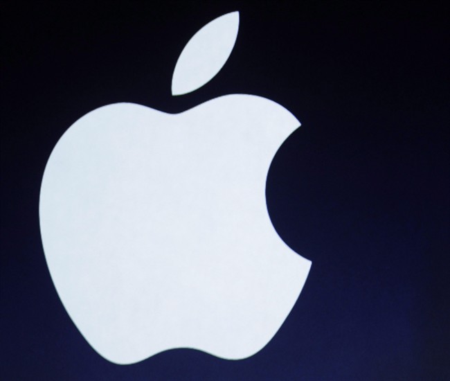 In this photo taken March 7, 2012, the Apple logo is projected during an announcement in San Francisco.
