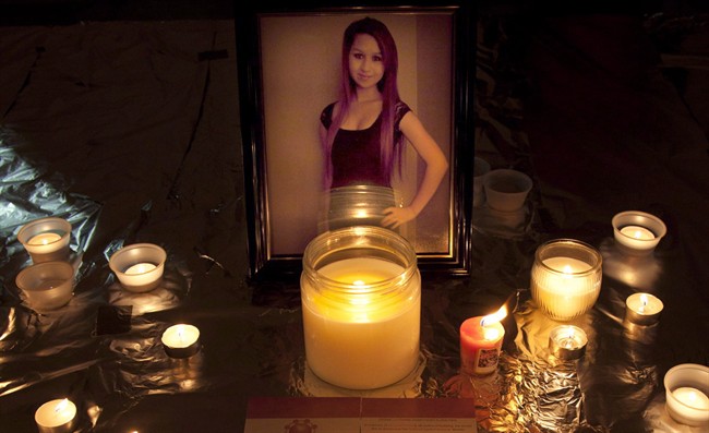 Candles are seen in front of a picture of Amanda Todd during a memorial in Surrey, B.C., Oct. 19, 2012. THE CANADIAN PRESS/Jonathan Hayward.