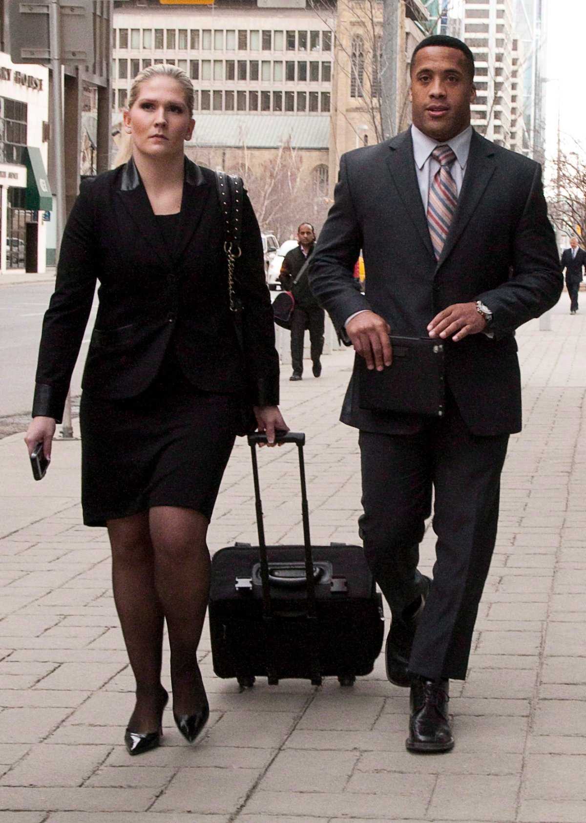 Former Calgary Stampeders player Joffrey Reynolds, right, leaves court with his lawyer Randi Collins in Calgary, Alta., Thursday, Feb. 7, 2013. 