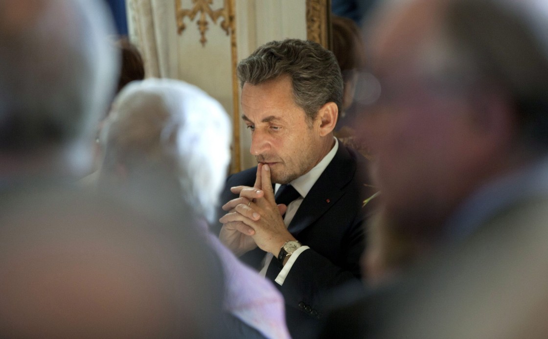 Former French President Nicolas Sarkozy, center, waits for his turn to speak during a medal ceremony at the Egmont Palace in Brussels on Wednesday, March 27, 2013.