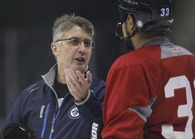 Winnipeg Jets coach Claude Noel talks to Dustin Byfuglien at training camp in Winnipeg on Tuesday, January 15, 2013. 