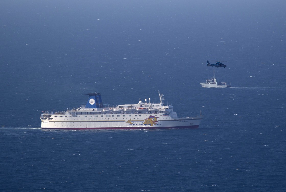 An Israeli military naval ship and an Israeli air force helicopter operate next to a cruise ship off the coast of Haifa, northern Israel, Thursday, April 25, 2013.  Israel shot down a drone Thursday as it approached the country's northern coast, the military said. Suspicion immediately fell on the Hezbollah militant group in Lebanon.