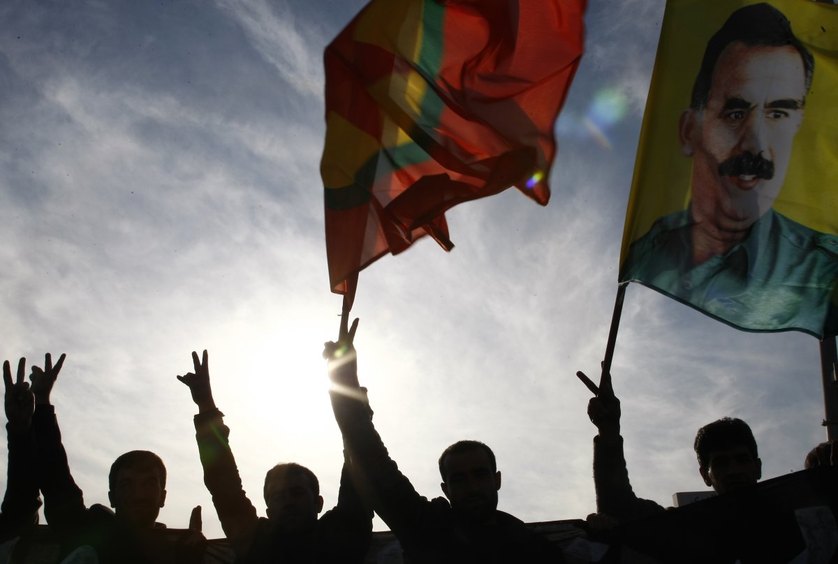 Kurdish demonstrators hold up flags as they protest in Arbil on December 30, 2011 .