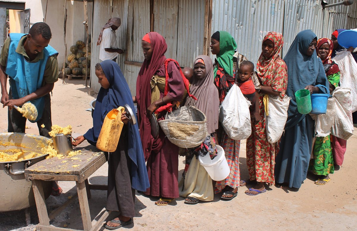 Somali women and children wait in line at a feeding centre in the capital, Mogadishu, on July 21, 2012.