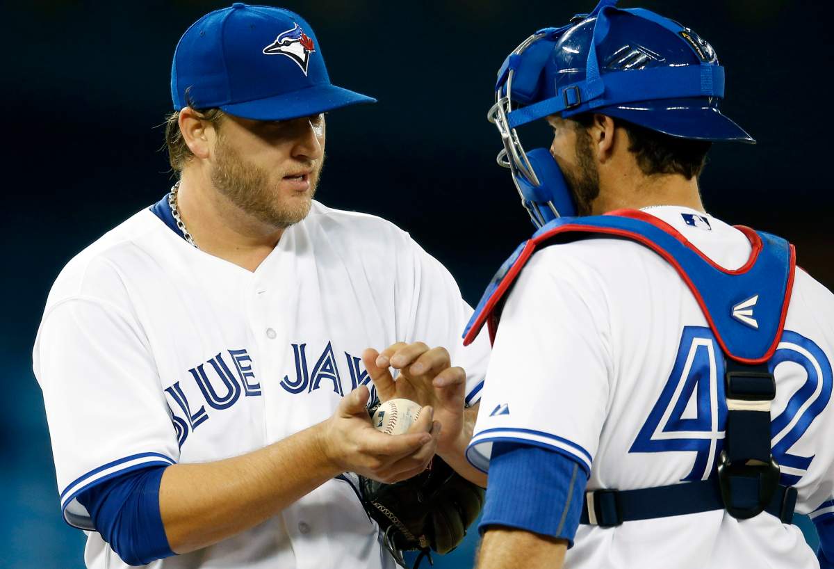 Mark Buehrle of the Toronto Blue Jays gets a visit to the mound from J.P. Arencibia during MLB game action against the Chicago White Sox on April 15, 2013 at Rogers Centre in Toronto, Ontario, Canada.