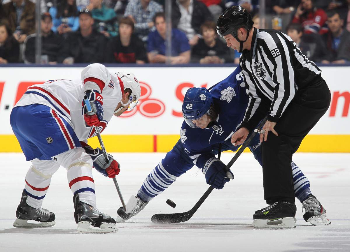 Tomas Plekanec #14 of the Montreal Canadiens takes a faceoff against Tyler Bozak #42 of the Toronto Maple Leafs on April 13, 2013 at the Air Canada Centre in Toronto, Canada.