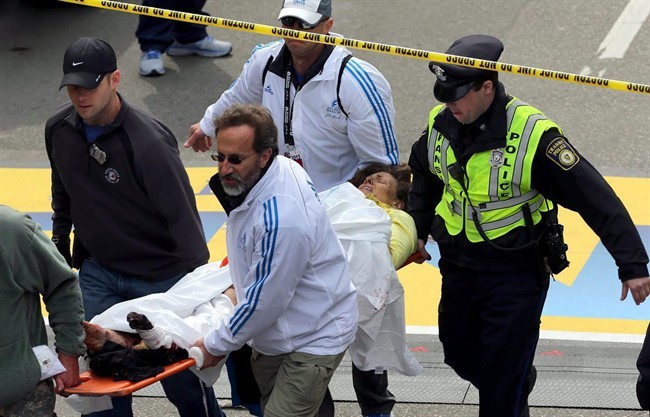 Medical workers aid injured people at the finish line of the 2013 Boston Marathon following an explosion in Boston, Monday, April 15, 2013. 