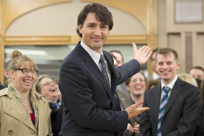 Liberal Leader Justin Trudeau gestures for media to leave so he can begin his first caucus meeting as leader, Wednesday April 17, 2013 in Ottawa. 
