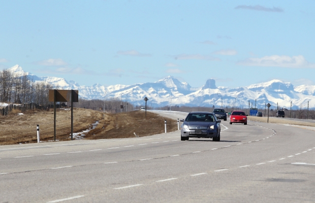 In this file photo, vehicles travel along a road in the Rockies in Alberta.