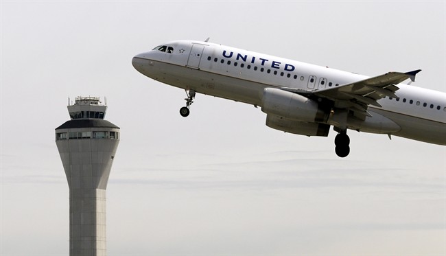 A United Airlines jet departs in view of the air traffic control tower at Seattle-Tacoma International Airport, April 23, 2013, in Seattle. 