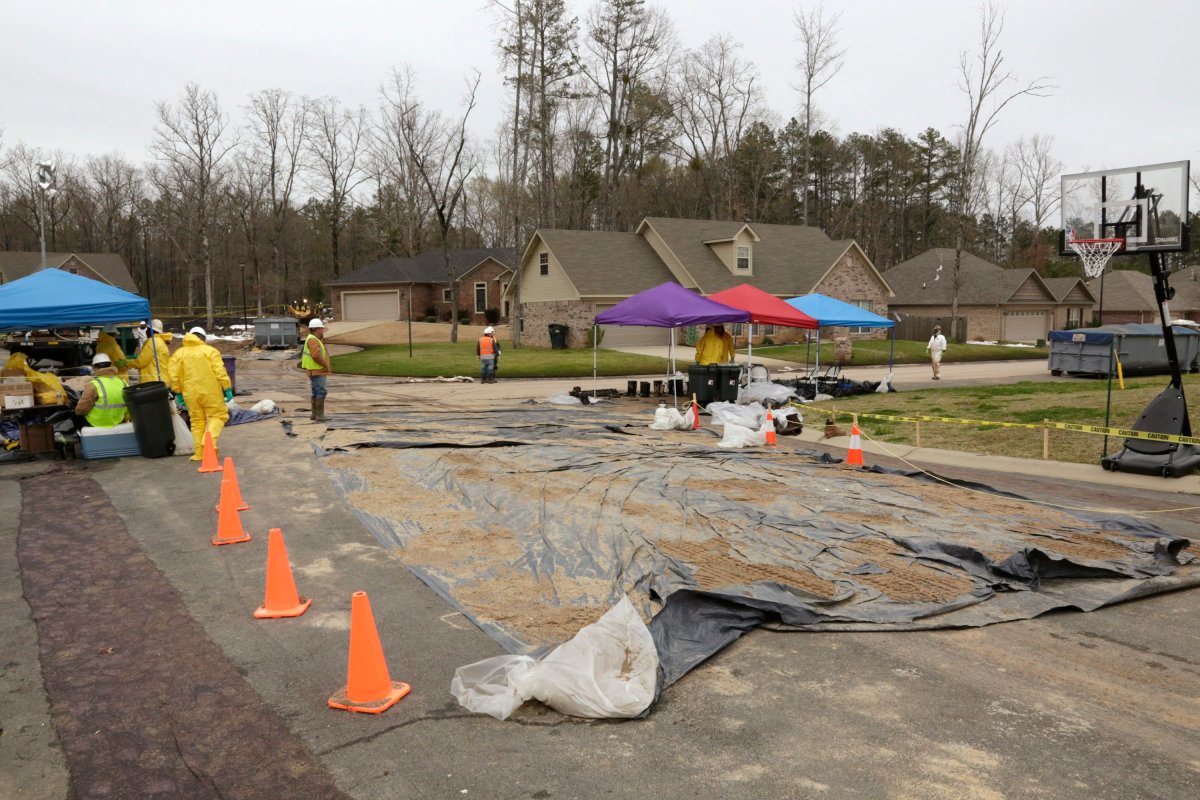 Crews work to clean up from an oil pipeline spill in a Mayflower, Ark., neighborhood Wednesday, April 3, 2013. An ExxonMobil pipeline ruptured last week and spewed thousands of barrels of crude oil.