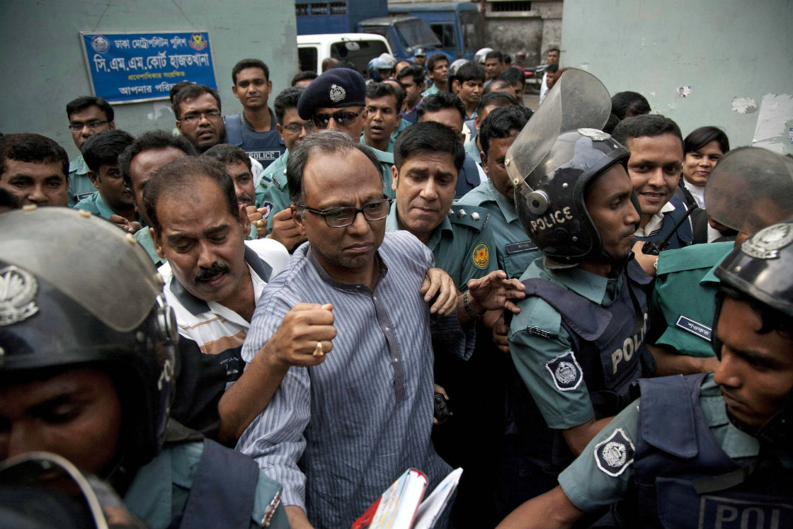 Bangladeshi newspaper editor Mahmudur Rahman, center, is brought to a court following his arrest in Dhaka, Bangladesh, Thursday, April 11, 2013. Police in Bangladesh arrested the acting editor of the pro-opposition Bengali-language Amar Desh newspaper on various charges. Leaders of the government's ruling party have recently accused the daily of inciting violence during recent political unrest. 