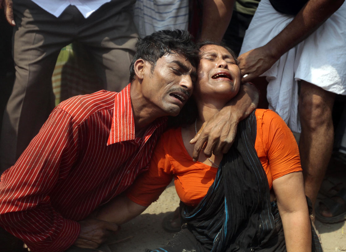 Relatives mourn a victim at the site after an eight-story building housing several garment factories collapsed near Dhaka, Bangladesh.   
