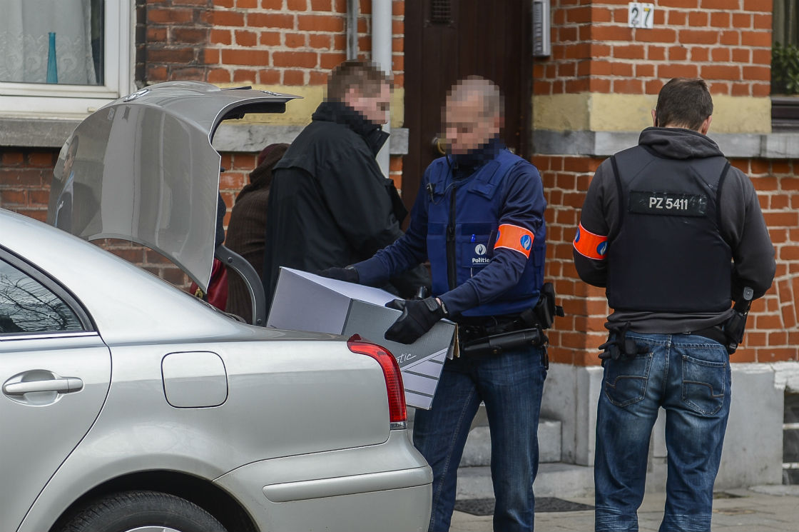 Police officers load the trunk of a car with evidence seized during a search on April 16, 2013 at a house in the Vilvoorde station area. Belgian police staged dozens of early morning raids on April 16 on radical Islamists suspected of recruiting volunteers to fight the regime of Syrian President Bashar al-Assad.
