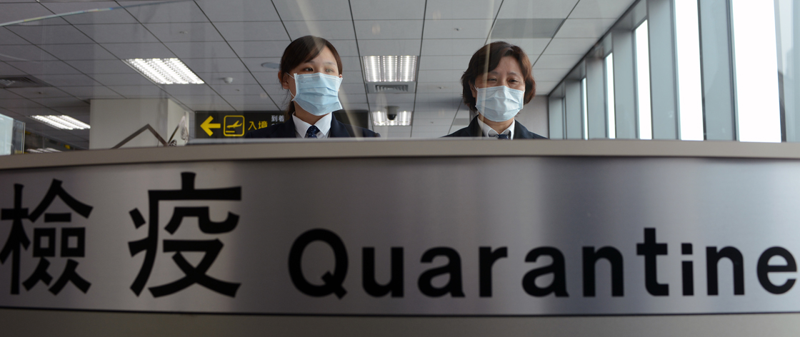 Taiwan's Center for Disease Control (CDC) staff stand at the entrance of Sungshan Airport in Taipei on April 4, 2013.